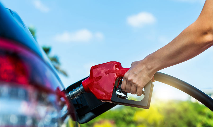 A person pumping gas into their vehicle.